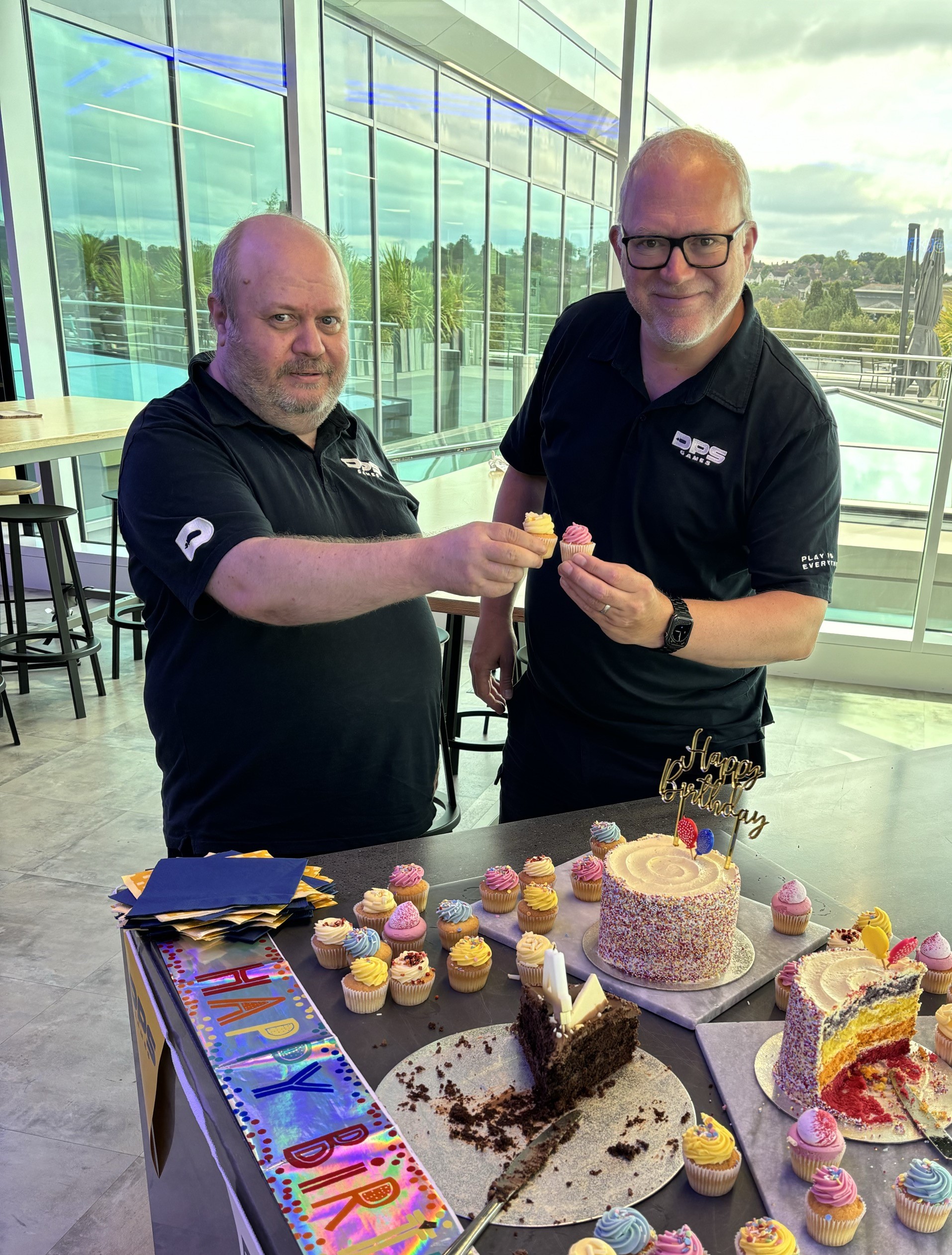 Two colleagues with cupcakes